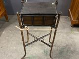 a small table with a drawer on it in the middle of a room