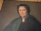 portrait of a woman in a black dress and a green shawl