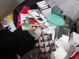 a pile of clothing and other items on a bed