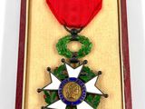 a red box with a medal and a wreath on it