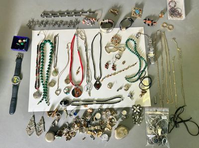 many different types of necklaces and bracelets laid out on a table
