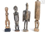three wooden figurines sitting next to each other on a white surface