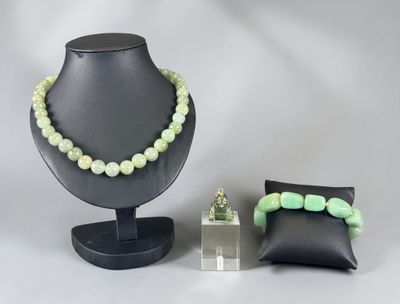 two pieces of jewelry on display on a table