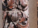 carvings on the side of a building with a clock on it