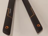 pair of black and orange electric tools sitting on top of a white table