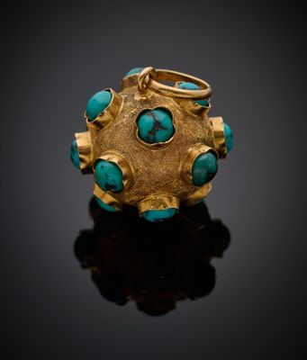 un gros plan sur une bague en or sertie de pierres de turquoise