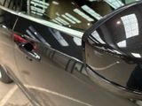 a reflection of a person in the side mirror of a car