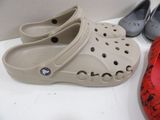 several pairs of crocs are lined up on a table
