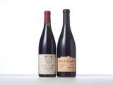 two bottles of wine sitting next to each other on a table