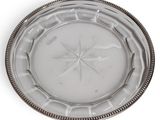 silver and glass plate with a star design on the rim