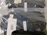 three pairs of hats and a wallet in a plastic bag