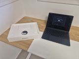 a laptop computer sitting on a table next to a box