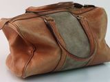 leather handbag on white surface with white background