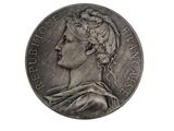 an old silver coin with a woman ' s head on it
