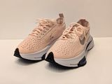 Les baskets Nike Air Max sont rose pâle et noires.