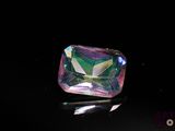 an image of a pink and green diamond on a black surface