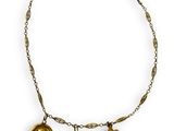 a close up of a necklace on a white background