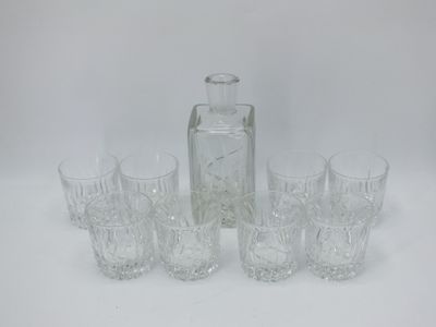 six verres et une carafe posés sur une table