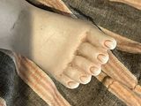 a close up of a doll ' s feet on a blanket