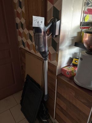 a vacuum in the corner of a kitchen next to a counter