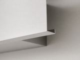 a close up of a white shelf with a square piece of paper on top of it