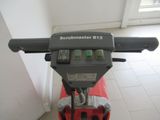 an image of a red schwinmaster machine in a room
