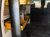 an image of the inside of a van with the door open