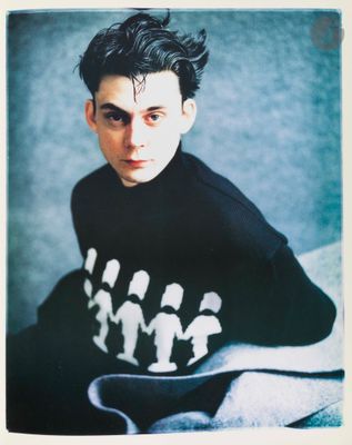 the man is wearing a black shirt with white figures on it