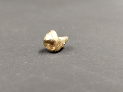 un gros plan sur un petit objet en or posé sur une table