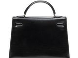 a black leather handbag on a white background