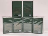 four boxes of green tea sitting on top of a white table