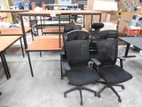 two office chairs that are sitting in the middle of a room
