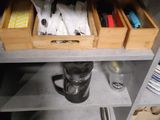 a kitchen with a sink and a counter with a lot of drawers