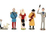 de nombreuses figurines représentant différentes personnes et un chien, sur fond blanc