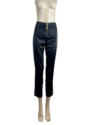 the mannequin is wearing a pair of black pants and a white top