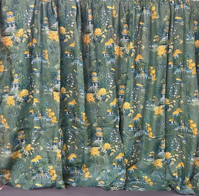 yellow and green floral curtains hanging on a wall in a room