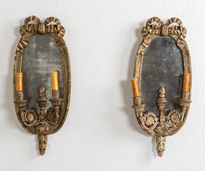 paire de miroirs anciens fixés au mur avec des bougeoirs