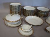 a lot of plates and cups that are on the table