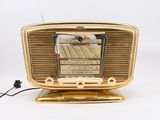 a gold radio that is sitting on top of a table