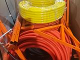 a box with a bunch of orange and yellow hoses in it