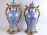 pair of blue and white vases with gold accents on a white background