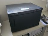 a microwave sitting on top of a shelf in a room