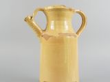 an image of a yellow vase sitting on top of a table
