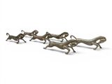 a group of bronze figurines of running dogs on a white background