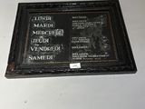 a plaque on the wall of a building that has a picture of a man on it