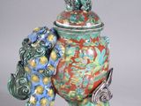 an image of a colorful vase sitting on top of a table