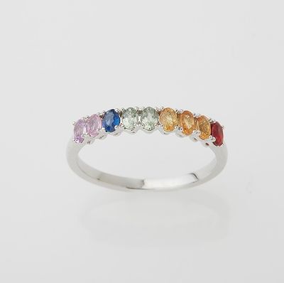 a multicolored rainbow stone ring on a white background