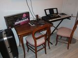 a small desk with a keyboard and a chair in front of it