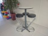 three stools and a table in a room