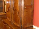 a large wooden cabinet in the corner of a room